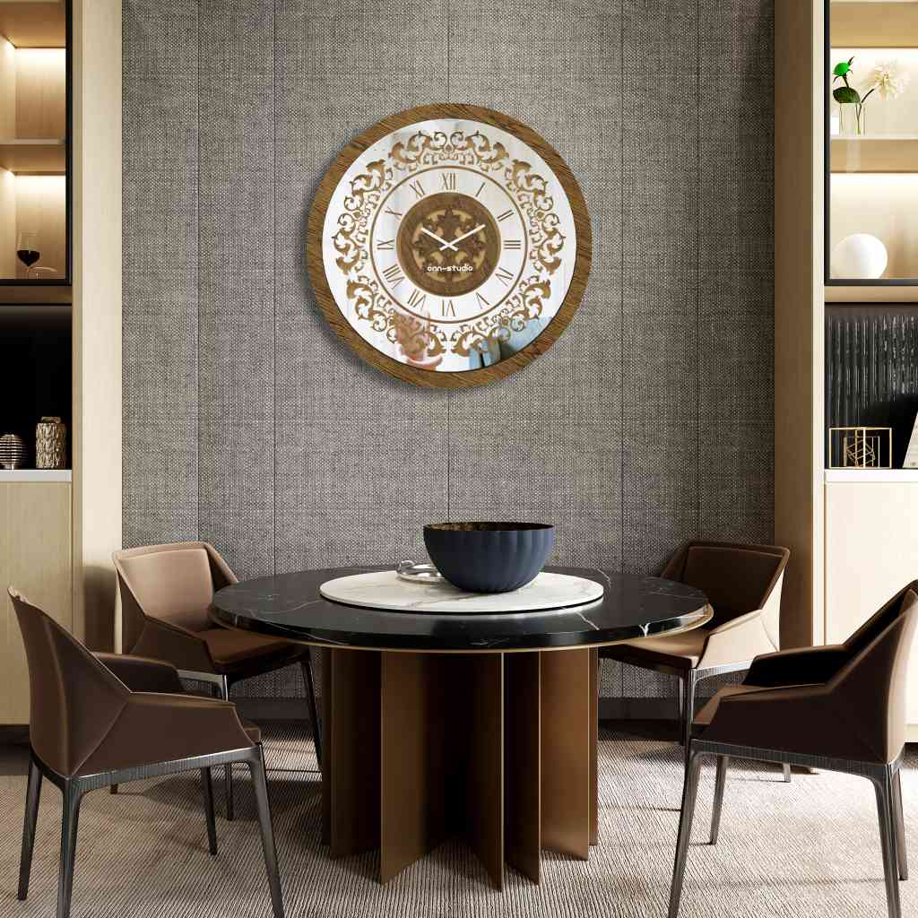 Round gold patina mirrored wall clock hanging in a grey dining room.