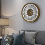 Add a touch of timeless elegance to your living space with this exquisite Round Unique Gold Patina Wall Clock. The intricate frame boasts a royal vintage effect, creating a luxurious atmosphere in any room. The mirrored design adds a touch of glamour, while the boho style clock enhances the overall aesthetic. Perfect for a chic living room, bedroom, or office, this stunning piece of wall art effortlessly combines style and functionality. Make a statement with this one-of-a-kind wall clock that will surely elevate your decor.