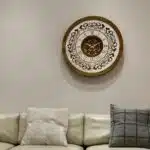 Add a touch of timeless elegance to your living space with this exquisite Round Unique Gold Patina Wall Clock. The intricate frame boasts a royal vintage effect, creating a luxurious atmosphere in any room. The mirrored design adds a touch of glamour, while the boho style clock enhances the overall aesthetic. Perfect for a chic living room, bedroom, or office, this stunning piece of wall art effortlessly combines style and functionality. Make a statement with this one-of-a-kind wall clock that will surely elevate your decor.