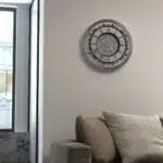 Introducing our stunning Roman Numeral Wall Clock, the perfect addition to your living room decor! This unique wall art piece features a chic vintage look with a round design in a beautiful silver patina finish. Elegant and timeless, this clock will make a statement in any room it's placed in. Elevate your space with this exquisite piece that combines functionality with style. Perfect for adding a touch of sophistication to your home, this Roman Numeral Wall Clock is sure to impress your guests and become a focal point in your space. Make a stylish statement with this elegant wall clock today!