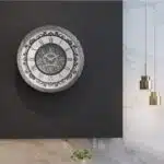 Introducing our stunning Roman Numeral Wall Clock, the perfect addition to your living room decor! This unique wall art piece features a chic vintage look with a round design in a beautiful silver patina finish. Elegant and timeless, this clock will make a statement in any room it's placed in. Elevate your space with this exquisite piece that combines functionality with style. Perfect for adding a touch of sophistication to your home, this Roman Numeral Wall Clock is sure to impress your guests and become a focal point in your space. Make a stylish statement with this elegant wall clock today!