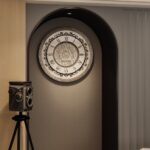 Add a touch of timeless elegance to your living room with this Roman Numeral Wall Clock. This unique wall art piece boasts a chic vintage look with its round design and silver patina finish. Its sophisticated appeal makes it the perfect addition to any stylish space, adding an elegant touch to your decor. Make a statement in your living room with this exquisite clock that is sure to impress your guests and elevate your room decor.