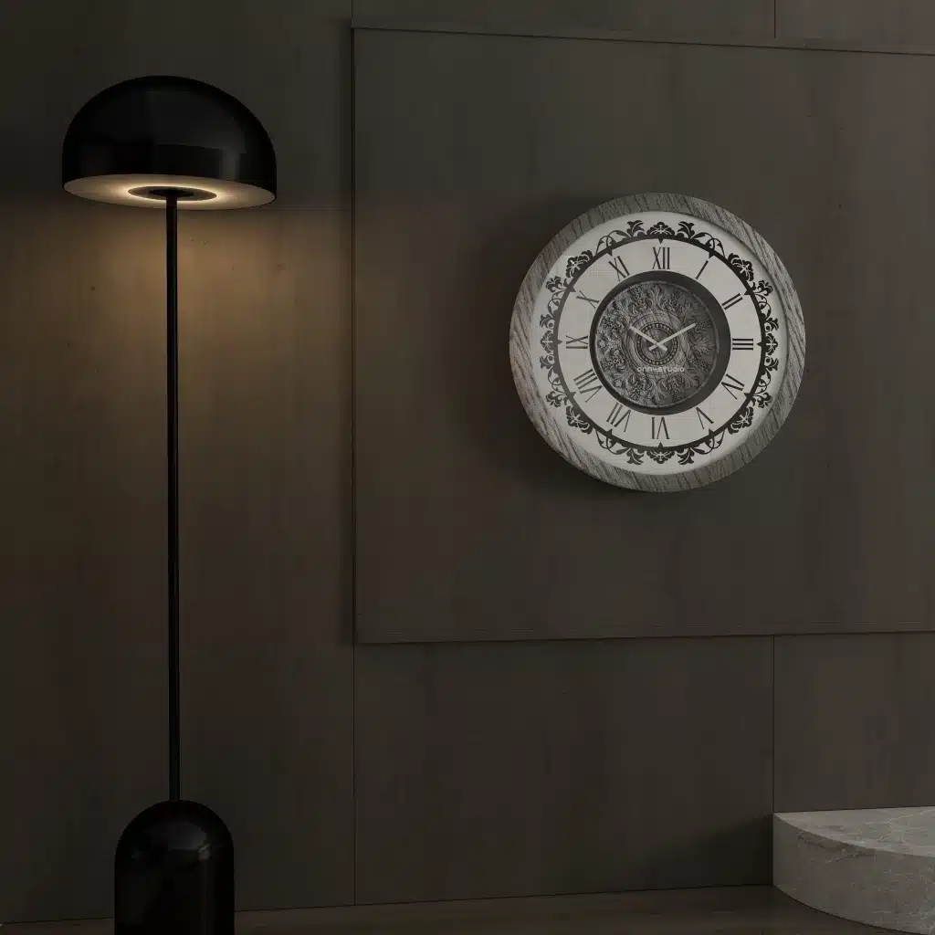 Add a touch of timeless elegance to your living room with this Roman Numeral Wall Clock. This unique wall art piece boasts a chic vintage look with its round design and silver patina finish. Its sophisticated appeal makes it the perfect addition to any stylish space, adding an elegant touch to your decor. Make a statement in your living room with this exquisite clock that is sure to impress your guests and elevate your room decor.