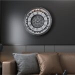 Add a touch of timeless elegance to your living room with this Roman Numeral Wall Clock. This unique wall art piece boasts a chic vintage look with its round design and silver patina finish. Its sophisticated appeal makes it the perfect addition to any stylish space, adding an elegant touch to your decor. Make a statement in your living room with this exquisite clock that is sure to impress your guests and elevate your room decor.