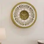 Add a touch of vintage charm to your home or office with this exquisite Vintage Floral Bronze Effect Wall Clock. Featuring elegant Roman numerals on a large round mirror, this artisan timekeeper is a statement piece that will elevate any space. Handmade with care, this wooden clock is perfect for adding a touch of sophistication to your living room decor. Make a statement with this elegant wall clock that combines beauty and functionality in one stunning piece.