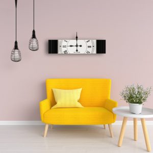 Rectangle black mirrored wall clock hanging in pink and yellow room.
