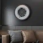 Add a touch of elegance to your space with this traditional round-shaped handmade wall clock adorned with 5 stunning surrounding colors - black, gray, gold, beige, and walnut. The captivating design feature of this piece is the intricate Persian calligraphy encircling the mirrored clock, creating a stylish one-of-a-kind look that shines beautifully on any wall. This large modern wall clock is not only a functional timepiece but also a stunning piece of art. With its oversized silhouette and silent mechanism, it is perfect for adding a bold statement to your kitchen or any room in your home. Make a stylish statement with this unique and eye-catching timepiece.