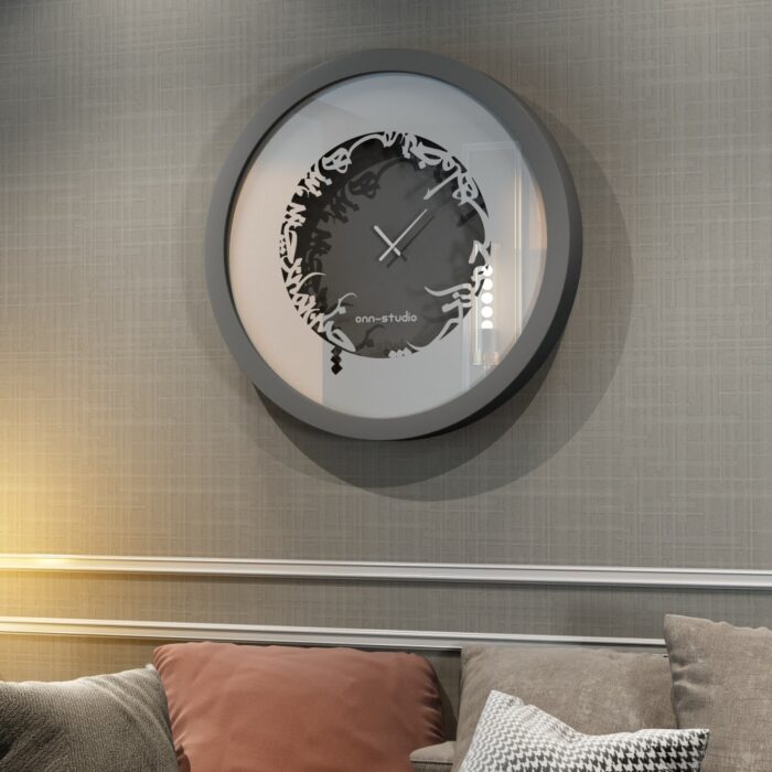 Add a touch of elegance to your space with this traditional round-shaped handmade wall clock adorned with 5 stunning surrounding colors - black, gray, gold, beige, and walnut. The captivating design feature of this piece is the intricate Persian calligraphy encircling the mirrored clock, creating a stylish one-of-a-kind look that shines beautifully on any wall. This large modern wall clock is not only a functional timepiece but also a stunning piece of art. With its oversized silhouette and silent mechanism, it is perfect for adding a bold statement to your kitchen or any room in your home. Make a stylish statement with this unique and eye-catching timepiece.