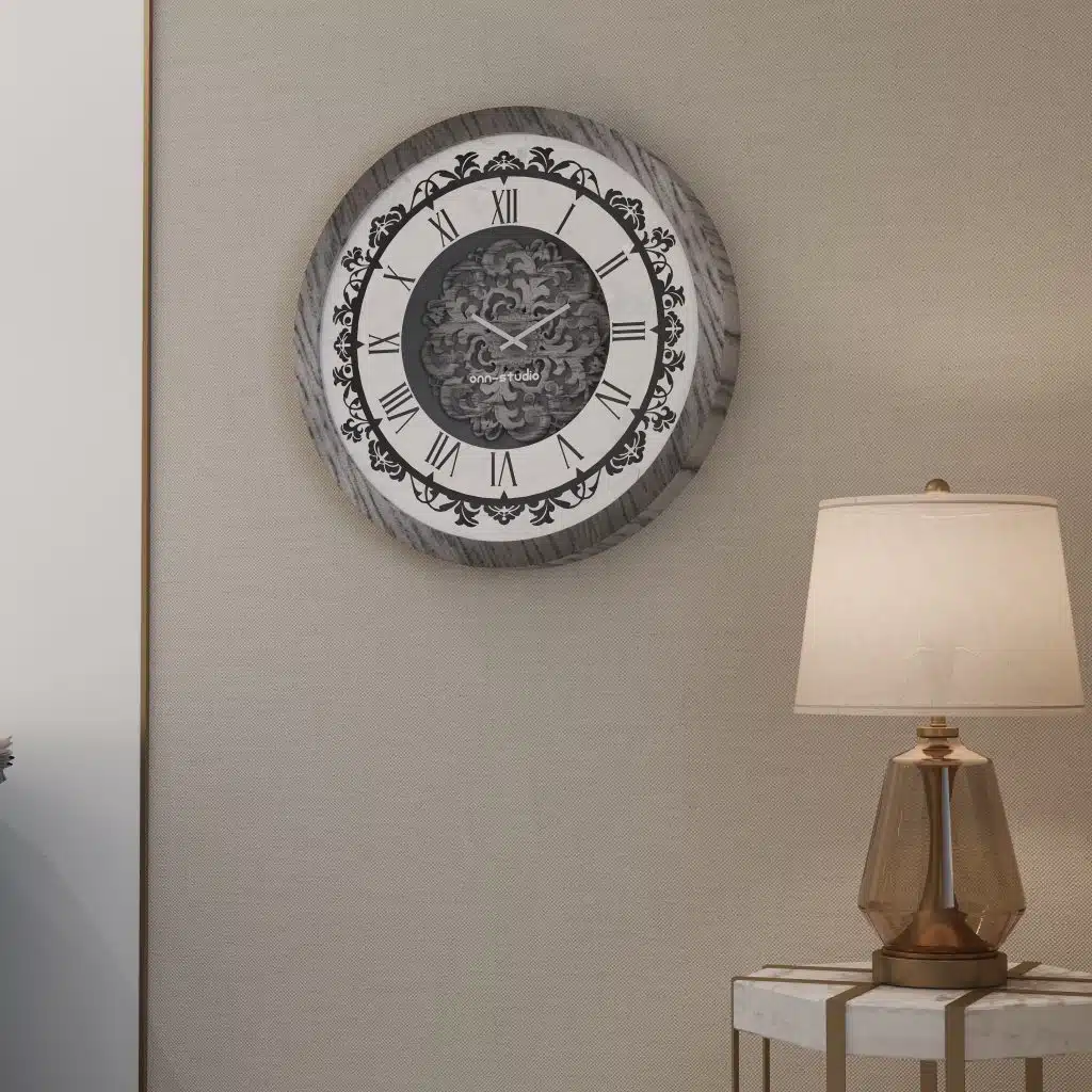 Add a touch of timeless elegance to your living room with this Roman Numeral Wall Clock. This unique wall art piece boasts a chic vintage look with its round design and silver patina finish. Its sophisticated appeal makes it the perfect addition to any stylish space, adding an elegant touch to your decor. Make a statement in your living room with this exquisite clock that is sure to impress your guests and elevate your room decor.
