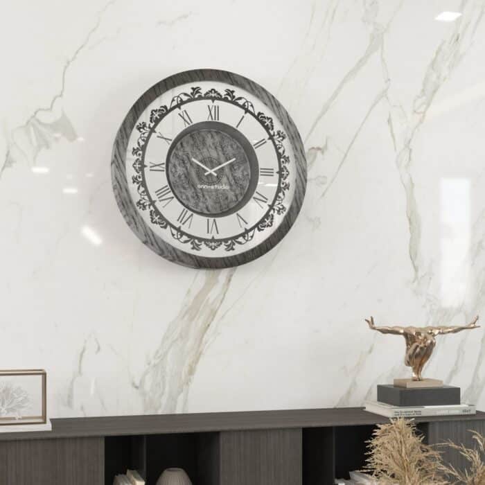 Introducing our stunning Roman Numeral Wall Clock, the perfect addition to your living room decor! This unique wall art piece features a chic vintage look with a round design in a beautiful silver patina finish. Elegant and timeless, this clock will make a statement in any room it's placed in. Elevate your space with this exquisite piece that combines functionality with style. Perfect for adding a touch of sophistication to your home, this Roman Numeral Wall Clock is sure to impress your guests and become a focal point in your space. Make a stylish statement with this elegant wall clock today!