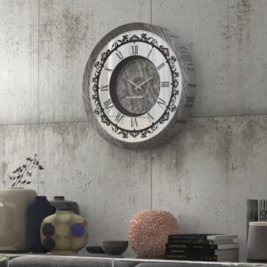 Introducing our stunning Roman Numeral Wall Clock, the perfect addition to your living room decor! This unique wall art piece features a chic vintage look with a round design in a beautiful silver patina finish. Elegant and timeless, this clock will make a statement in any room it's placed in. Elevate your space with this exquisite piece that combines functionality with style. Perfect for adding a touch of sophistication to your home, this Roman Numeral Wall Clock is sure to impress your guests and become a focal point in your space. Make a stylish statement with this elegant wall clock today!