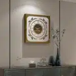 Add a touch of Boho style charm to your living space with this unique Roman Numeral Mirror Clock. This chic vintage square wall clock in patina gold is not just a timepiece, but a piece of elegant home decor that will elevate the look of your living room. With its intricate Roman numerals and stylish design, this clock is sure to be a conversation starter and a focal point in any room. Bring a touch of sophistication and vintage flair to your home with this stunning wall art piece.
