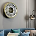 Add a touch of timeless elegance to your home or office with this stunning Vintage Floral Bronze Effect Wall Clock. Featuring classic Roman numerals on a large round mirror, this artisan timekeeper is sure to make a statement in any room. Handmade with care, this elegant wall clock is the perfect addition to your living room decor or as a centerpiece for your space. Crafted from high-quality wood, this unique clock is both functional and stylish, making it a beautiful and practical accent piece for your home. Elevate your interior with this exquisite handmade clock today!