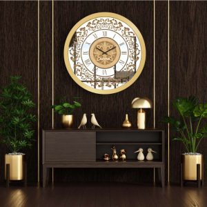 Round gold mirrored wall clock hanging in a dark brown room.