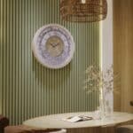 Handmade round Roman numeral wall clock with beige wooden frame and patina floral mirror design