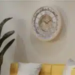 Handmade round Roman numeral wall clock with beige wooden frame and patina floral mirror design
