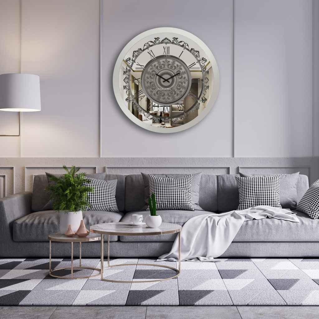 Round plain siver mirrored wall clock hanging in a light grey room.