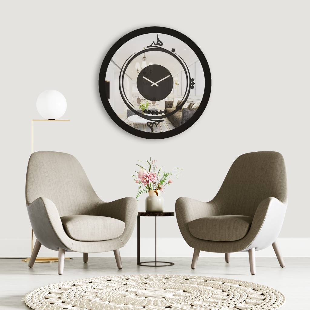 Round black Persian calligraphy mirrored wall clock hanging in white room.