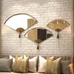 Add a touch of modern elegance to your living room with this unique asymmetrical mirror. This irregular fan-shaped mirror is the perfect addition to any space, whether used as a statement piece or as a functional bathroom vanity mirror. The combination of large and small mirrors creates a visually stunning design that will instantly elevate your home decor. Give the gift of style with this one-of-a-kind mirror, a perfect housewarming present for anyone who appreciates a contemporary and minimal aesthetic.