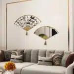 Add a touch of modern elegance to your living room with this unique asymmetrical mirror. This irregular fan-shaped mirror is the perfect addition to any space, whether used as a statement piece or as a functional bathroom vanity mirror. The combination of large and small mirrors creates a visually stunning design that will instantly elevate your home decor. Give the gift of style with this one-of-a-kind mirror, a perfect housewarming present for anyone who appreciates a contemporary and minimal aesthetic.