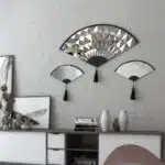 Add a touch of modern elegance to your living room décor with this unique asymmetrical mirror. Perfect for adding a contemporary flair to any space, this irregular fan-shaped mirror is both stylish and functional. Whether it's hanging in the bathroom as a vanity mirror or displayed in the living room as a statement piece, this mirror is sure to impress. Available in both large and small sizes, it also makes a thoughtful housewarming gift for your loved ones. Upgrade your home with this modern and minimalistic mirror today!