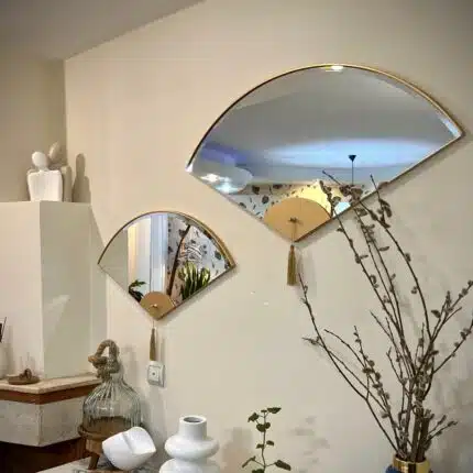 Add a touch of modern elegance to your living room décor with this unique asymmetrical mirror. Perfect for adding a contemporary flair to any space, this irregular fan-shaped mirror is both stylish and functional. Whether it's hanging in the bathroom as a vanity mirror or displayed in the living room as a statement piece, this mirror is sure to impress. Available in both large and small sizes, it also makes a thoughtful housewarming gift for your loved ones. Upgrade your home with this modern and minimalistic mirror today!