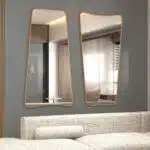 Elevate your home decor with this stunning Wavy Asymmetrical Gold Wall Mirror. Perfect for adding a touch of modern chic flair to your bathroom vanity or living room, this elegant and irregularly shaped mirror will instantly upgrade the aesthetic of any space. The sophisticated gold frame adds a touch of luxury, making it a stylish and versatile addition to your home decor. Make a statement with this unique and eye-catching piece that is sure to become a focal point in any room.
