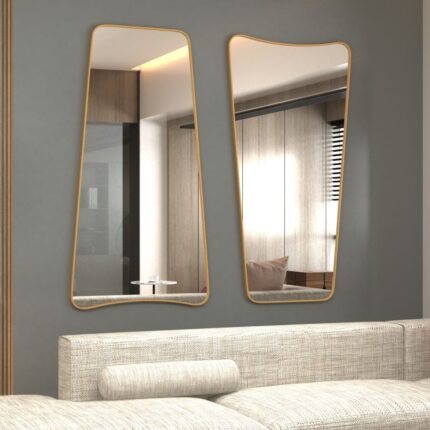 Elevate your home decor with this stunning Wavy Asymmetrical Gold Wall Mirror. Perfect for adding a touch of modern chic flair to your bathroom vanity or living room, this elegant and irregularly shaped mirror will instantly upgrade the aesthetic of any space. The sophisticated gold frame adds a touch of luxury, making it a stylish and versatile addition to your home decor. Make a statement with this unique and eye-catching piece that is sure to become a focal point in any room.