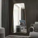 Introducing our stunning Wavy Asymmetrical Gold Wall Mirror, the perfect addition to your bathroom vanity or living room decor. This modern chic home decor piece features an irregular design that adds a touch of elegance to any space. The wavy shape of the mirror creates a unique and eye-catching look, making it a must-have for those seeking a stylish vanity aesthetic. Add a touch of sophistication to your home with this elegant and versatile mirror.