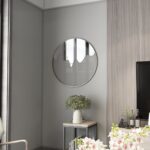 Elevate your living room decor with this stunning Round Decorative Vanity Mirror. Handcrafted with a unique design, this mirror serves as a statement piece that will surely impress your guests. Its modern design and minimalist style make it a perfect addition to any chic wall art collection. Ideal for housewarming decor or simply to add a touch of sophistication to your space. Upgrade your home with this stylish Wall Mirror today!