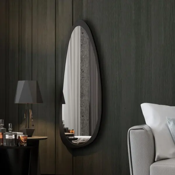 Add a touch of modern elegance to your space with this Mid Century Asymmetrical Black Mirror. This striking piece features an irregular design, making it a unique addition to any room. Whether used as a bathroom vanity mirror or as stylish living room décor, this large wall mirror is sure to make a statement. Perfect for her, this mirror also makes a thoughtful housewarming gift for that special someone who loves contemporary style. Elevate your decor with this one-of-a-kind piece that combines functionality with fashion.