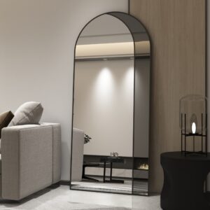 Add a touch of contemporary elegance to your living space with this Modern Arched Floor Mirror. This full-length lean wall mirror features an asymmetrical design, perfect for adding a chic flair to your housewarming decor. Use it as a leaner mirror in your bedroom or living room to create the illusion of a larger space while adding a stylish statement piece. Elevate your home decor with this stunning and sleek large mirror that will instantly upgrade any room in your house.