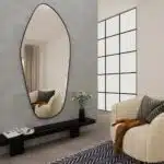 Add a touch of modern elegance to your space with this stunning ASYMMETRICAL VANITY MIRROR. This unique piece features an Irregular Mirror design that is perfect for adding a stylish flair to your Entryway or Bathroom. The Gold Wall Mirror adds a glamorous touch, while the Large Mirror size makes it perfect for wall décor or as a Full length Mirror. Elevate your home decor with this chic and versatile piece that is sure to make a statement in any room.