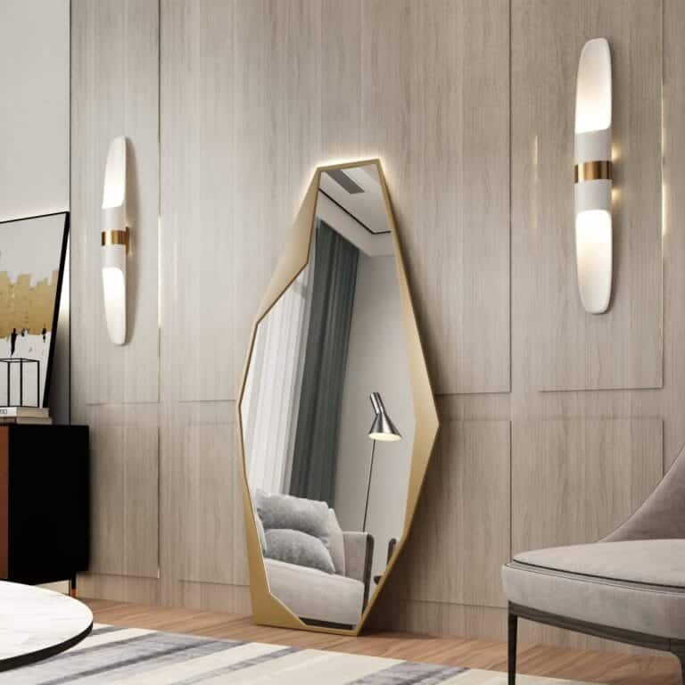 Add a touch of contemporary elegance to your living space with this Modern Full-Length Free Standing Irregular Gold Mirror. This Unique Asymmetrical Floor Mirror is not your average vanity mirror - its irregular shape and eye-catching design make it a standout piece of decor. Perfect for any room in your home, this Irregular Vanity Mirror will instantly elevate your space with its Aesthetic Design. Make a bold statement with this full body mirror that doubles as a stunning piece of art. Give your living room a stylish update with this striking and unique addition.