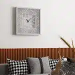 Add a touch of modern sophistication to your living room or kitchen decor with this unique large wall clock featuring a stunning 3D effect look design. This elegant timepiece is not only functional but serves as a stylish statement piece for any home. This oversized clock is available in black, gray, gold, beige, and silver, perfect for complementing any color scheme. Whether for yourself or as a housewarming gift idea, this silent, square wall clock will surely impress. Elevate your space with this chic and contemporary piece that embodies both form and function.