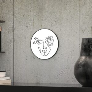 "Etched line drawing of a woman's face intertwined with a mix of flowers on a round wall mirror, showcasing intricate and artistic design."