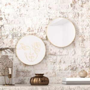 "Etched line drawing of a woman's face intertwined with a mix of flowers on a round wall mirror, showcasing intricate and artistic design."