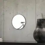 Small round handmade wall mirror with Persian calligraphy design featuring the word 'Freedom' etched on the mirror surface, available with black or gold frame.
