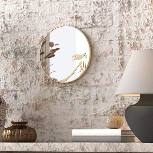 Small round handmade wall mirror with Persian calligraphy design featuring the word 'Freedom' etched on the mirror surface, available with black or gold frame.