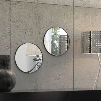 Small round handmade wall mirror with Persian calligraphy design featuring the word 'Freedom' etched on the mirror surface, available with black or gold frame.