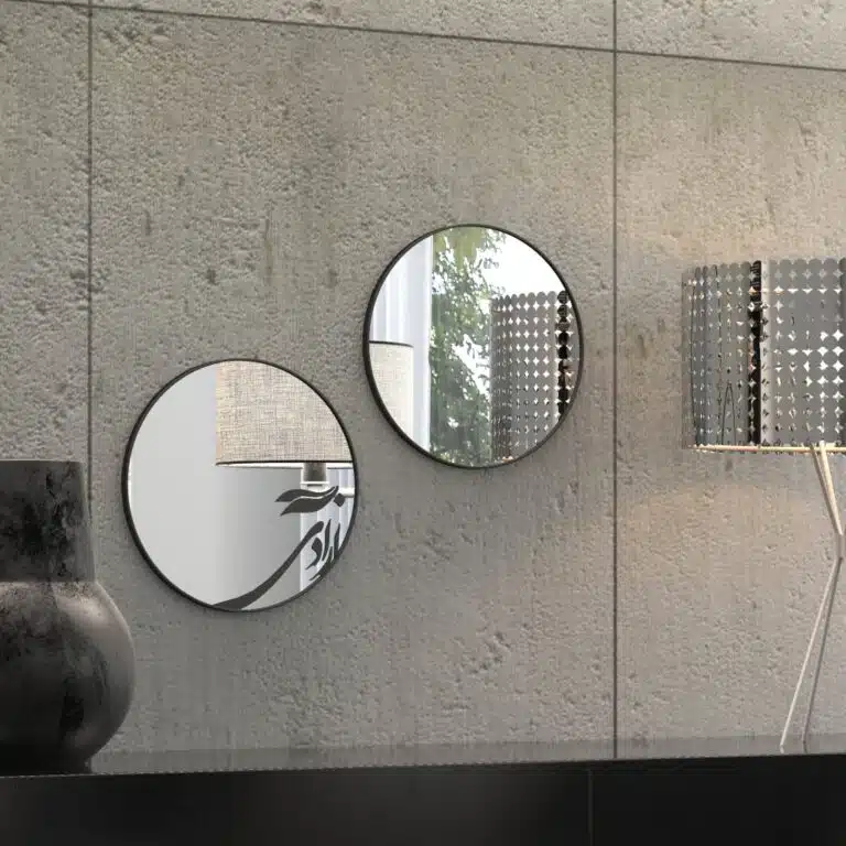 Small round handmade wall mirror with Persian calligraphy design featuring the word 'Freedom' etched on the mirror surface, available with black or gold frame.
