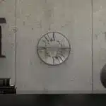 Small round wall mirror with an etched Persian calligraphy design featuring the words 'Women, Life, Freedom,' framed in a gold and black color scheme, hanging on a wall.