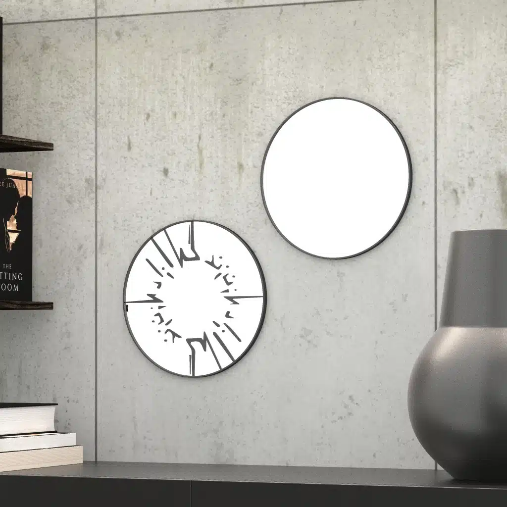 Small round wall mirror with an etched Persian calligraphy design featuring the words 'Women, Life, Freedom,' framed in a gold and black color scheme, hanging on a wall.