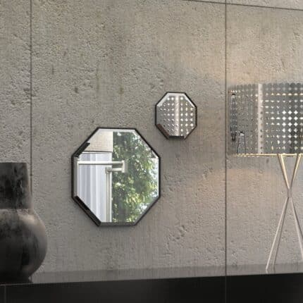 A octagonal wall mirror elegantly mounted on a wall adjacent to a well-stocked bookshelf, enhancing the room's aesthetic appeal.