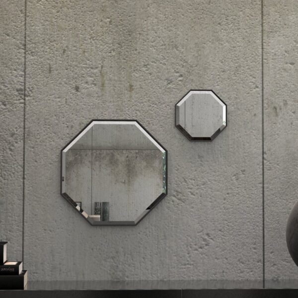 A octagonal wall mirror elegantly mounted on a wall adjacent to a well-stocked bookshelf, enhancing the room's aesthetic appeal.