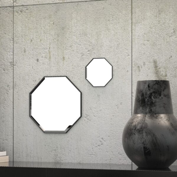 A octagonal wall mirror elegantly mounted on a wall adjacent to a well-stocked bookshelf, enhancing the room's aesthetic appeal.