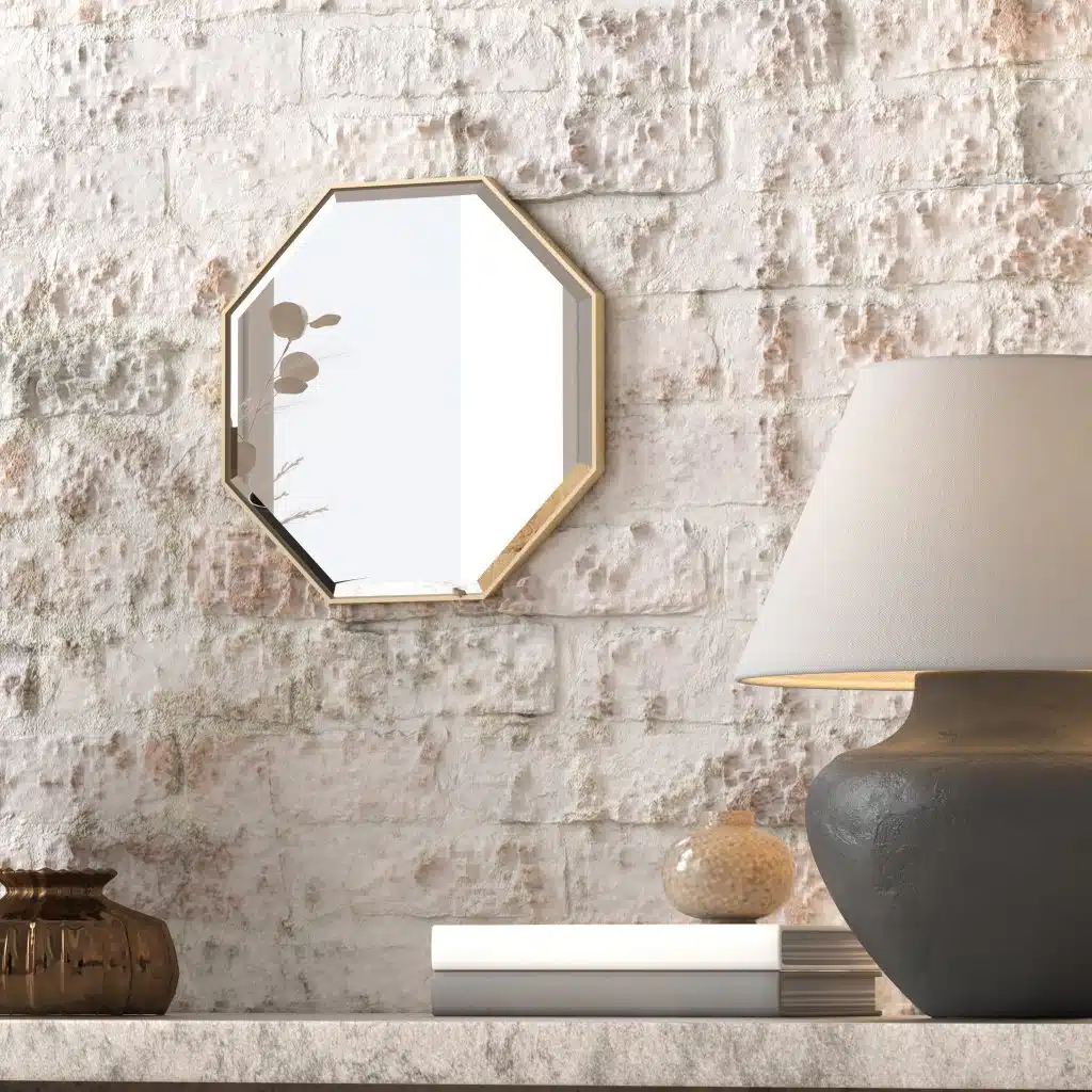 A octagonal wall mirror elegantly mounted on a wall adjacent to a well-stocked bookshelf, enhancing the room's aesthetic appeal.