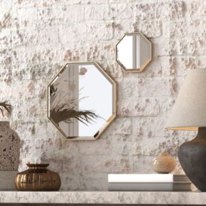 A octagonal wall mirror elegantly mounted on a wall adjacent to a well-stocked bookshelf, enhancing the room's aesthetic appeal.