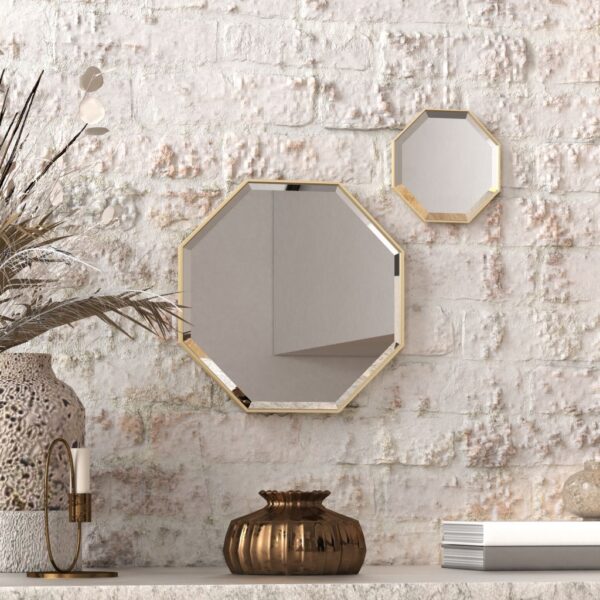 A octagonal wall mirror elegantly mounted on a wall adjacent to a well-stocked bookshelf, enhancing the room's aesthetic appeal.