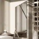 Full-length angled wall mirror with beveled diagonal lines and frameless design, available with black, gold, or silver wood backing.